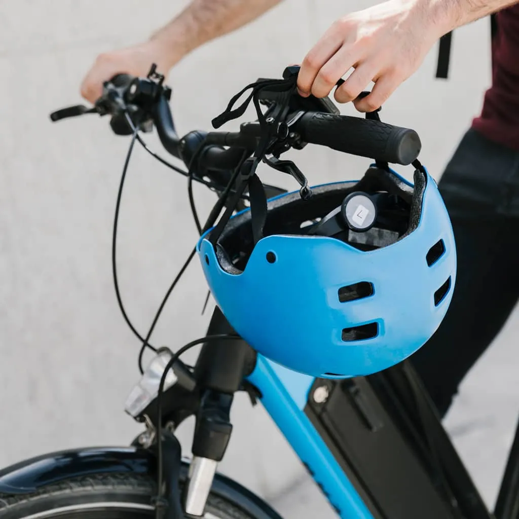 blue helmet on e-bike handlebar